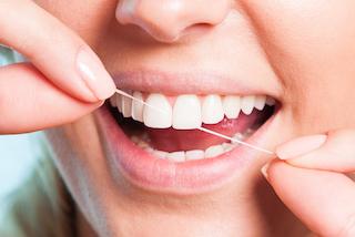  A closeup of a person flossing | Workman Family Dental