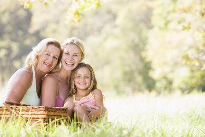 A family smiles in a meadow | Dental Bridges Columbia IL